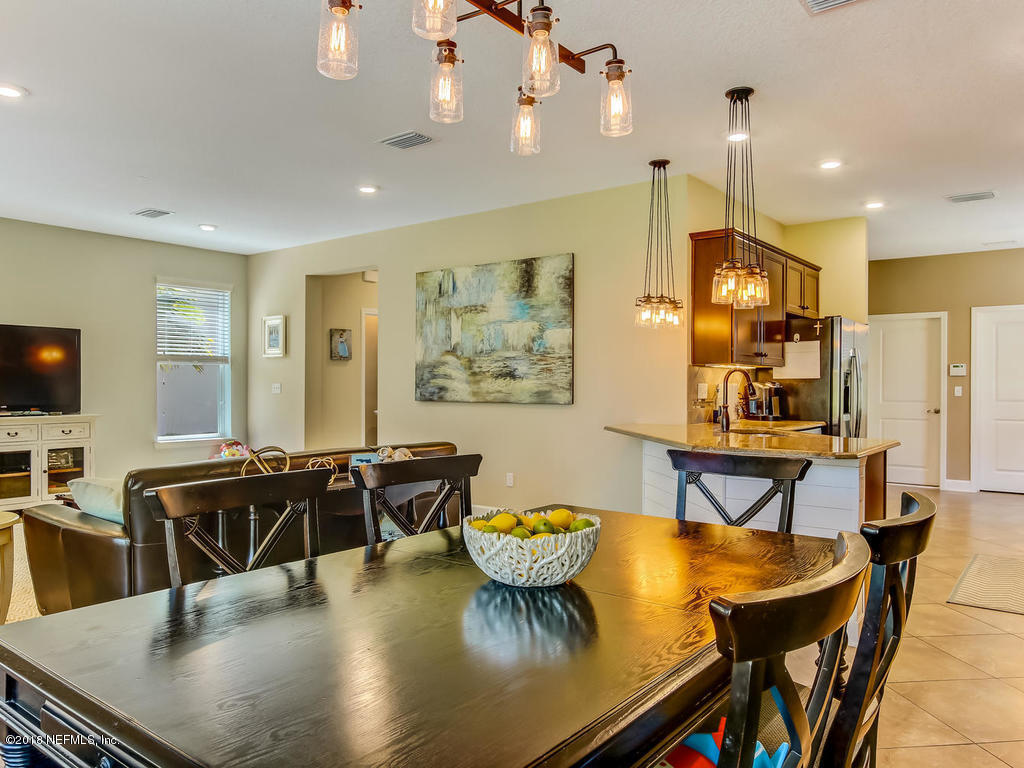 144 Maiden Terrace Ponte Vedra, FL 32081 - Photo 17 of 59 a view of a dining room with furniture and wooden floor