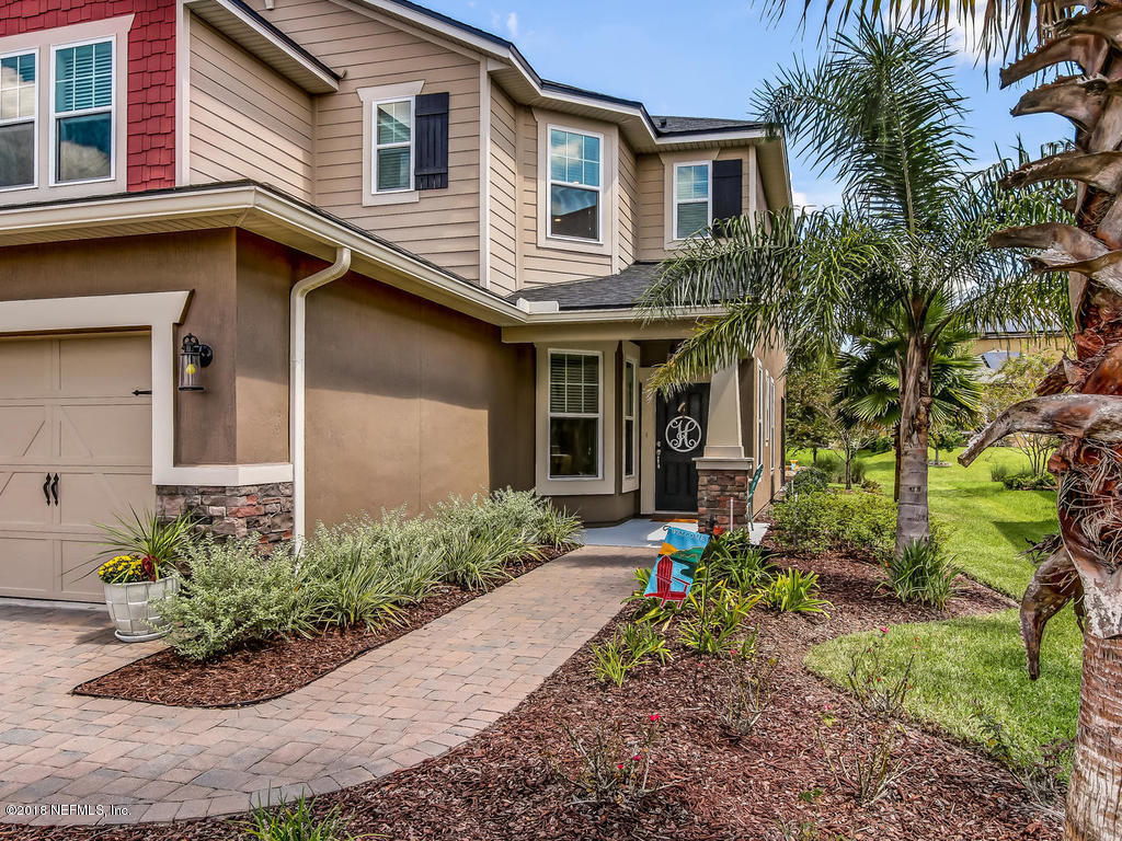 144 Maiden Terrace Ponte Vedra, FL 32081 - Photo 2 of 59 a front view of a house with a yard