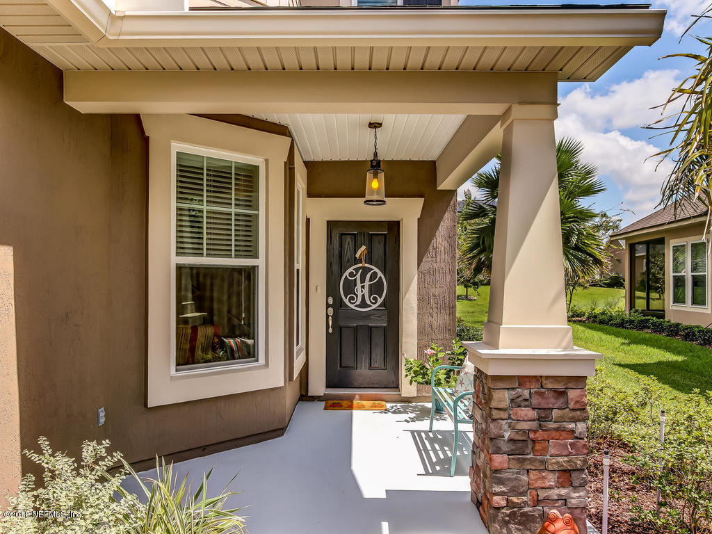 144 Maiden Terrace Ponte Vedra, FL 32081 - Photo 3 of 59 a front view of a house with garden