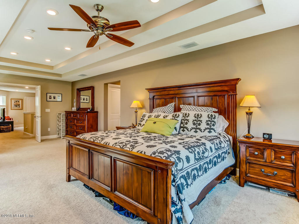 144 Maiden Terrace Ponte Vedra, FL 32081 - Photo 31 of 59 a bedroom with a bed and a chandelier