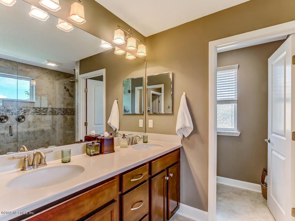 144 Maiden Terrace Ponte Vedra, FL 32081 - Photo 34 of 59 a bathroom with a double vanity sink and a mirror