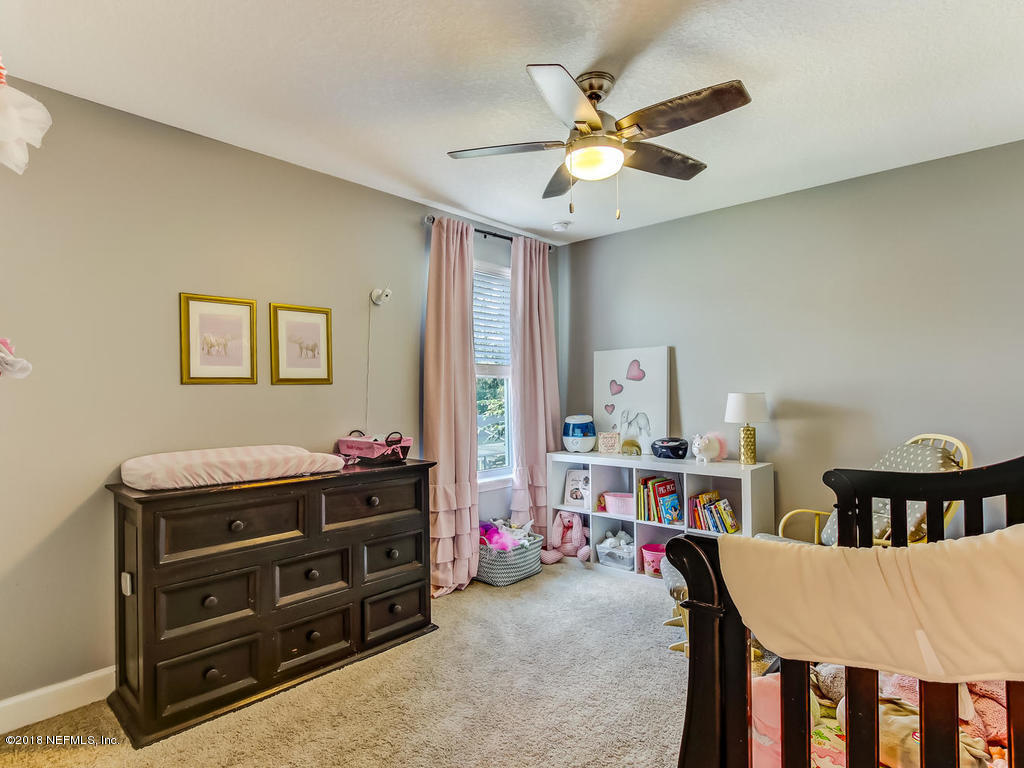 144 Maiden Terrace Ponte Vedra, FL 32081 - Photo 37 of 59 a living room with furniture and a flat screen tv