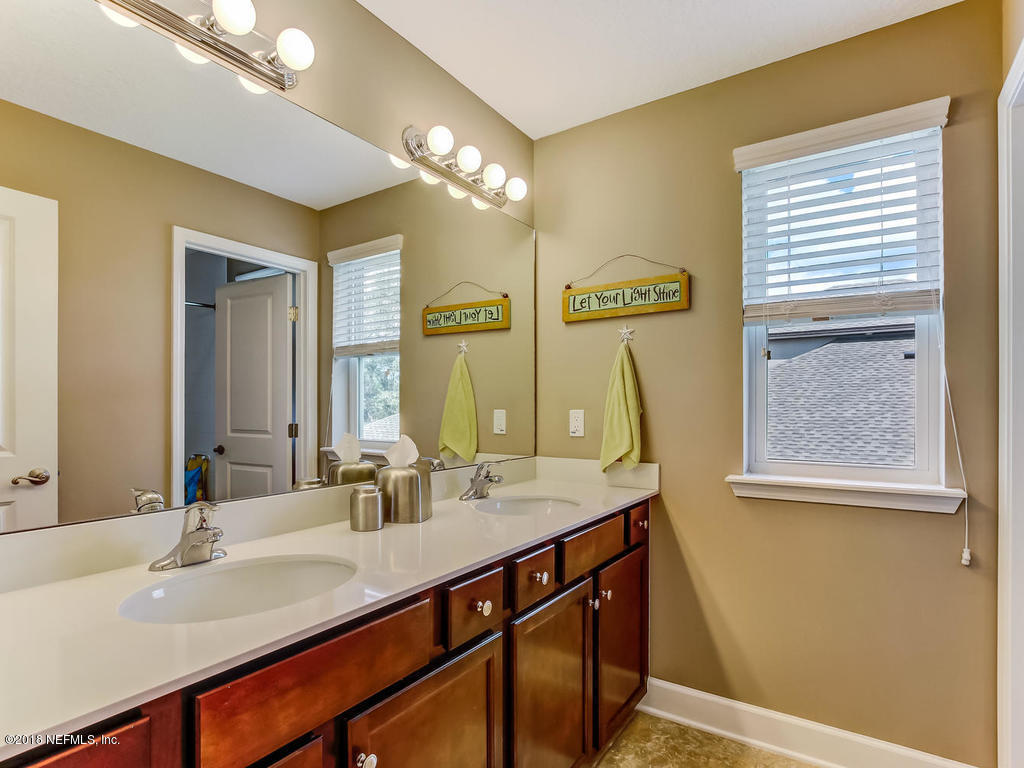 144 Maiden Terrace Ponte Vedra, FL 32081 - Photo 38 of 59 a bathroom with a double vanity sink and a mirror