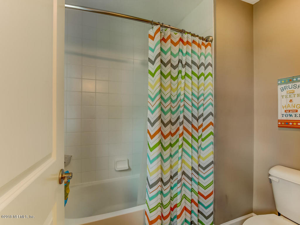 144 Maiden Terrace Ponte Vedra, FL 32081 - Photo 39 of 59 a bathroom with a toilet and a shower curtain