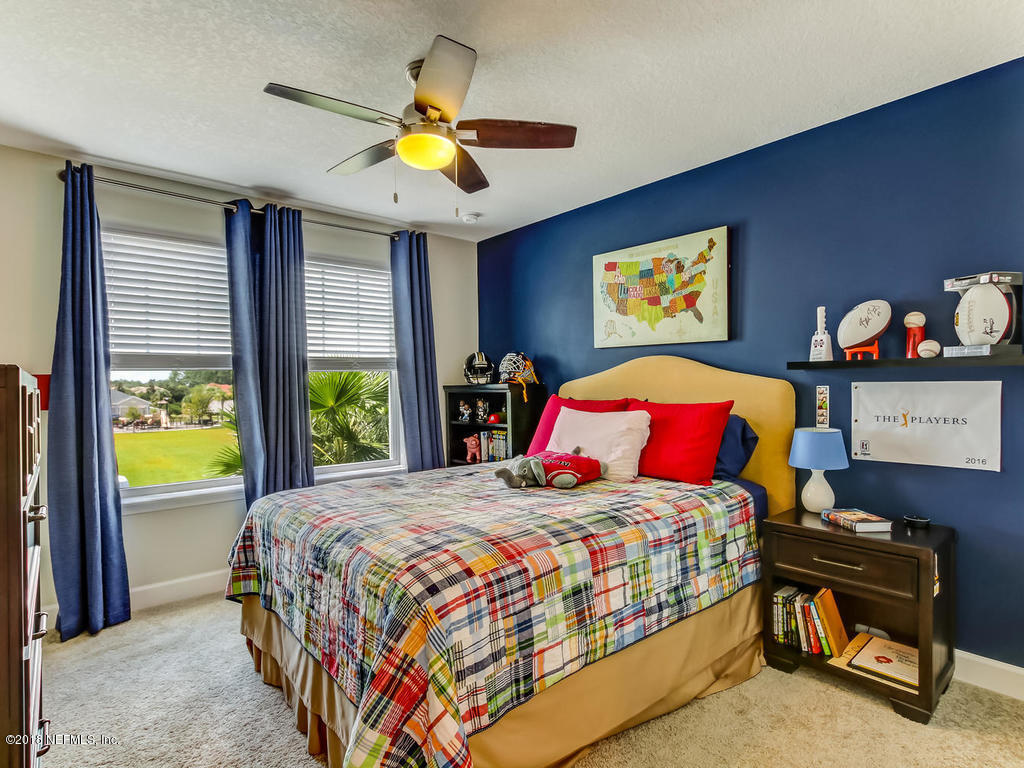 144 Maiden Terrace Ponte Vedra, FL 32081 - Photo 40 of 59 a bedroom with a bed and a chandelier