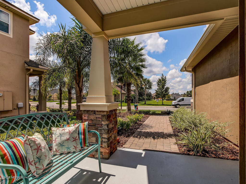 144 Maiden Terrace Ponte Vedra, FL 32081 - Photo 4 of 59 a view of a chairs and table in the back yard of the house