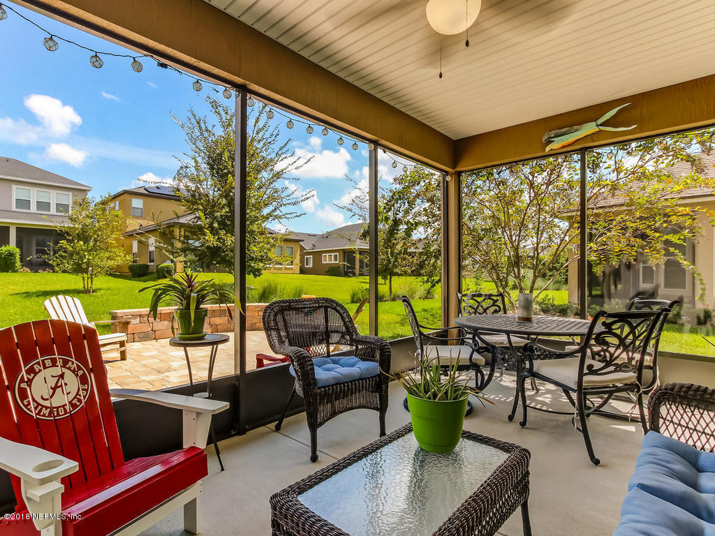 144 Maiden Terrace Ponte Vedra, FL 32081 - Photo 42 of 59 a living room with patio furniture and a floor to ceiling window
