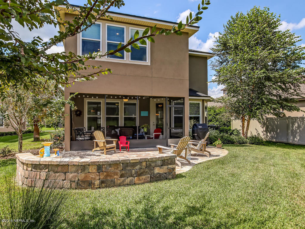144 Maiden Terrace Ponte Vedra, FL 32081 - Photo 49 of 59 a front view of a house with a yard garden and outdoor seating