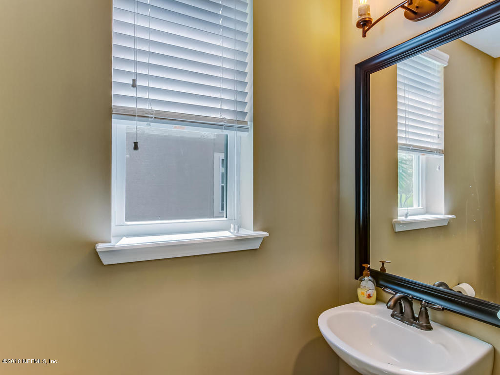 144 Maiden Terrace Ponte Vedra, FL 32081 - Photo 9 of 59 a bathroom with a sink and a mirror