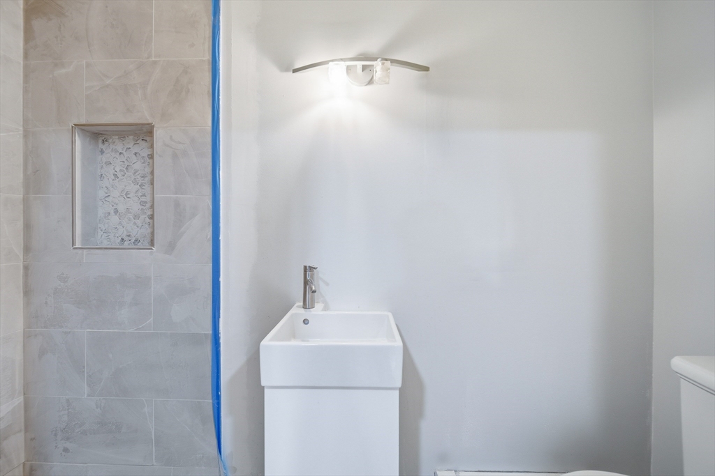 39 Hawthorne Street, Unit 39 Boston, MA 02119 - Photo 15 of 33 a bathroom with a sink and vanity