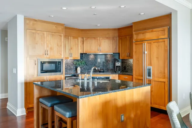 a kitchen with stainless steel appliances granite countertop a stove and a refrigerator
