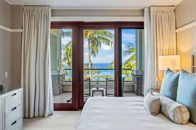 a bedroom with a large bed and a flat screen tv