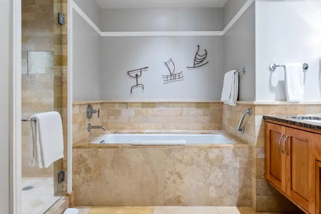 a bedroom with two beds and large window