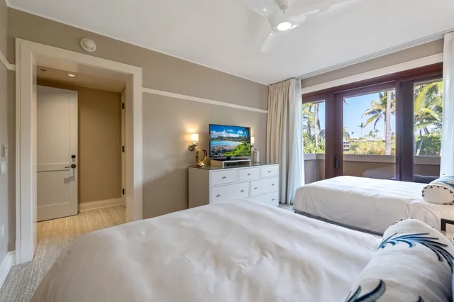 a bedroom with a large bed and a large window