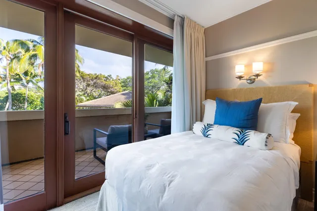 a bedroom with a bed and a flat screen tv in it