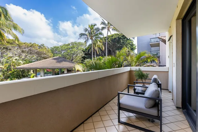 a bathroom with a granite countertop sink a toilet and a mirror