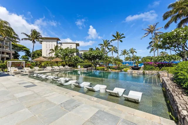 a backyard of a house with table and chairs under an umbrella