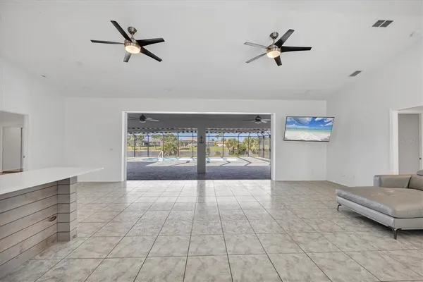 a view of a livingroom with furniture and a ceiling fan
