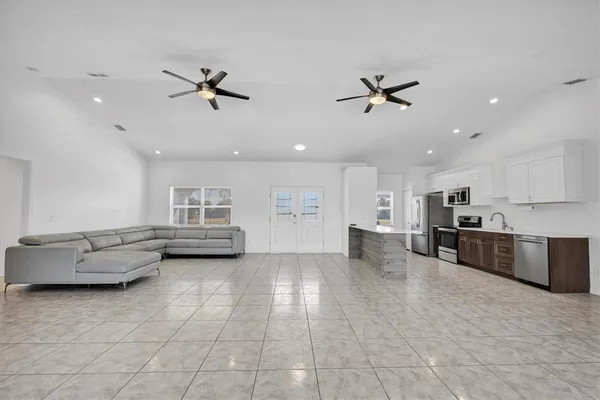 a kitchen with cabinets appliances and a sink