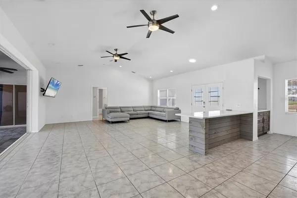 a view of a livingroom with a window and a ceiling fan