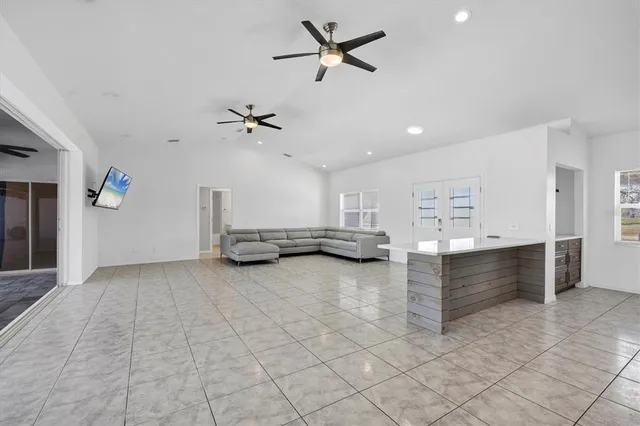a view of a livingroom with a window and a ceiling fan