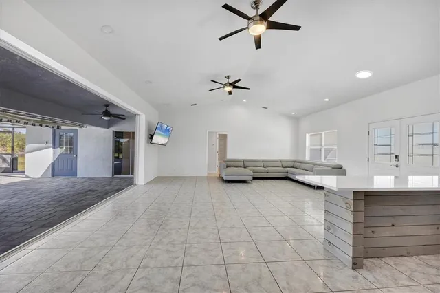 a view of a livingroom with a ceiling fan and window