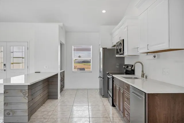 a bathroom with a tub a sink and a large mirror