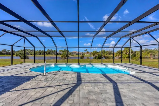 an aerial view of a city with lots of residential buildings ocean and mountain view in back