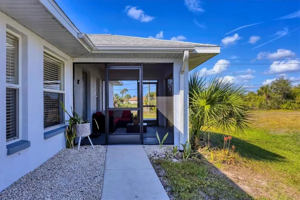 a sign of golf club on a wall under a tree