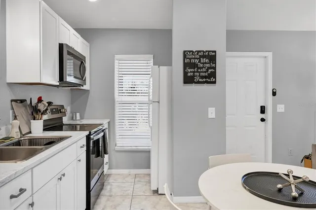 a sign of golf club on a wall under a tree