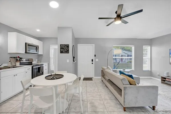 an aerial view of residential houses with outdoor space and trees