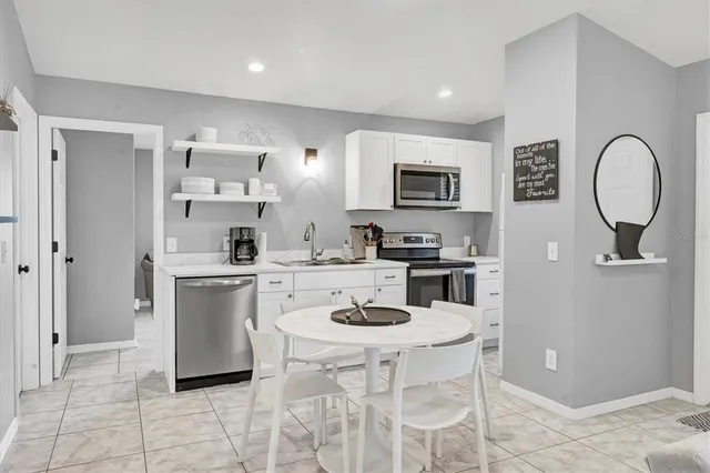 a view of a lake with a swimming pool and outdoor seating
