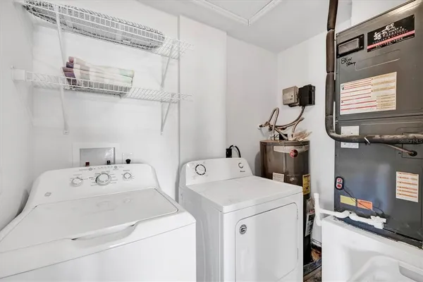 a kitchen with stainless steel appliances a refrigerator a sink a stove a dining table and chairs