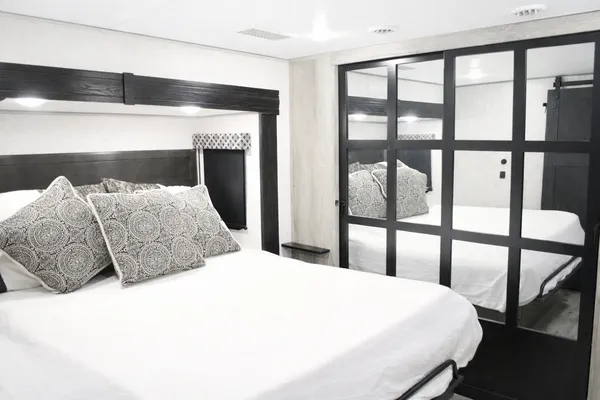a bedroom with a large bed and a large window