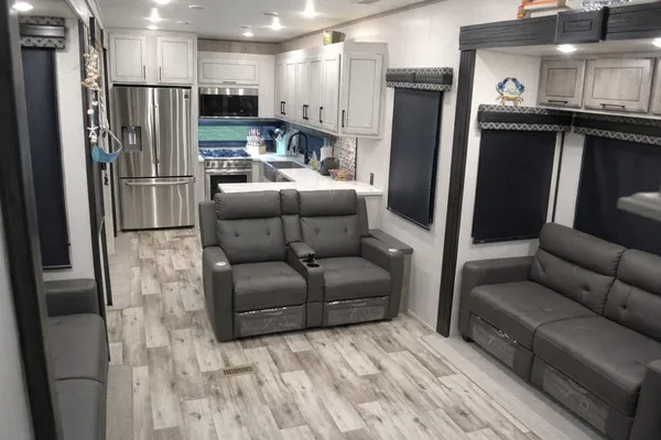 a living room with a couch and a refrigerator