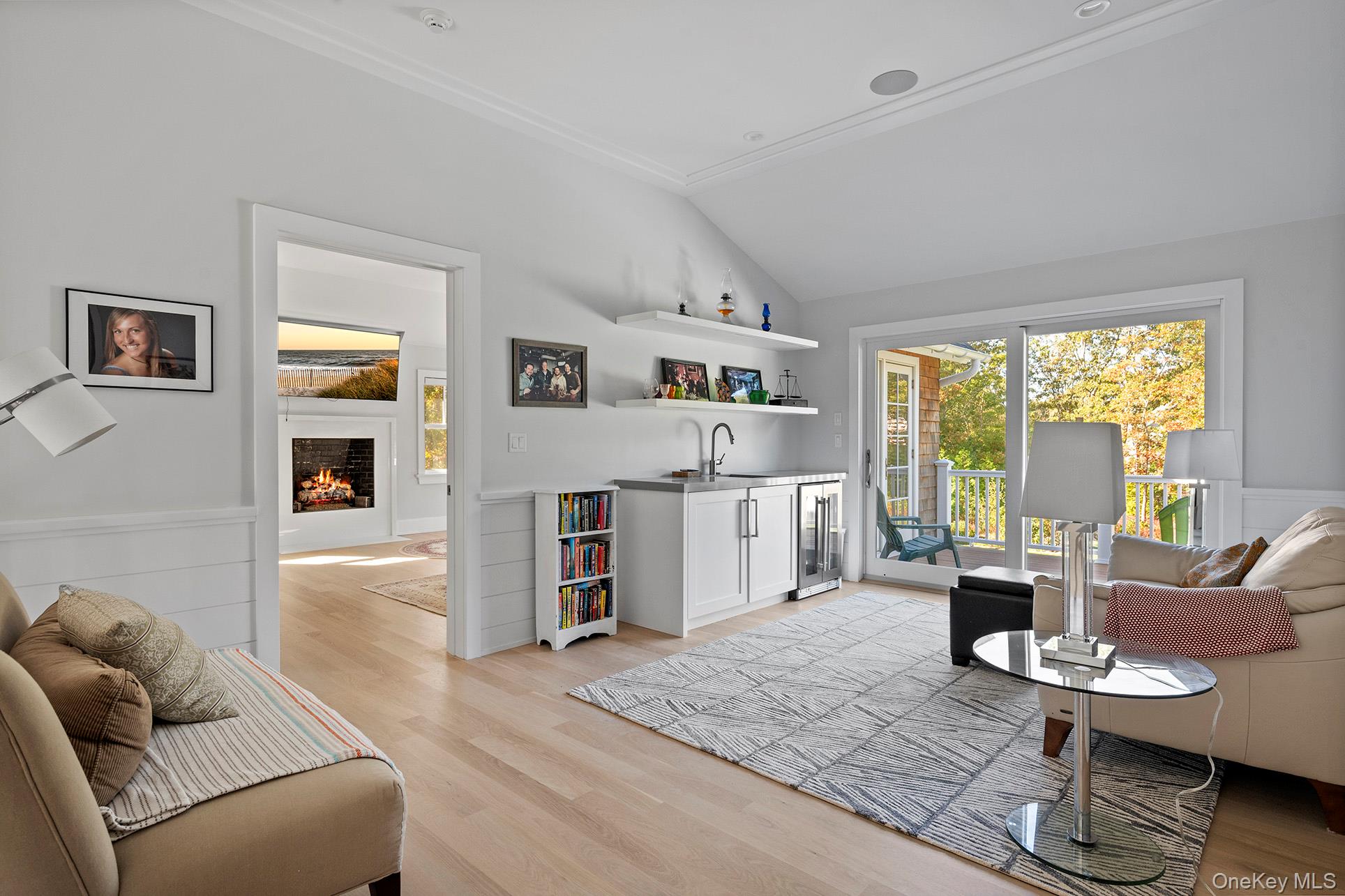41 Arbutus Road Quogue, NY 11959 - Photo 19 of 35 a living room with furniture a fireplace and a table