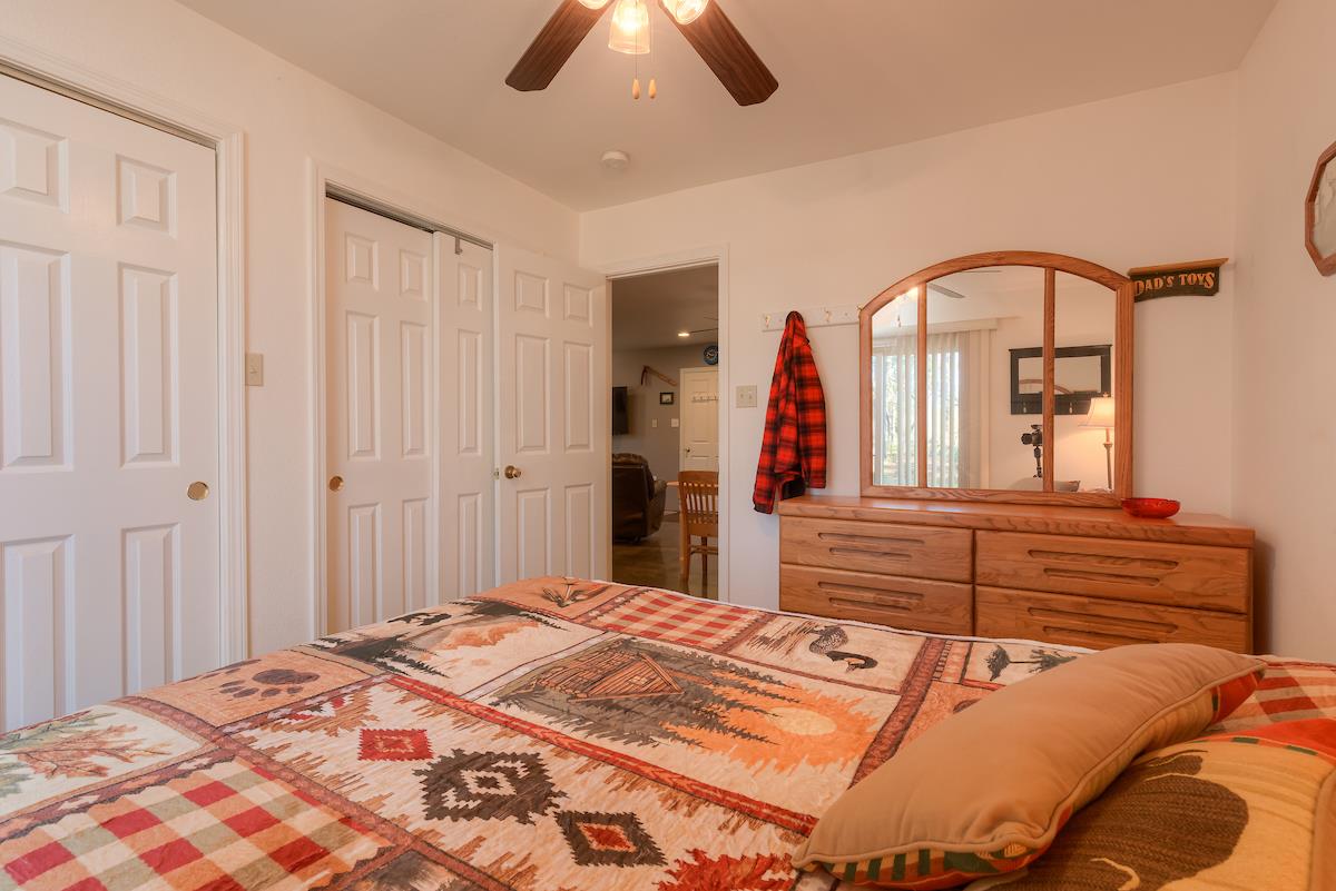 179 Elams Ranch Road Oroville, CA 95966 - Photo 13 of 52 a bedroom with a bed and a chandelier
