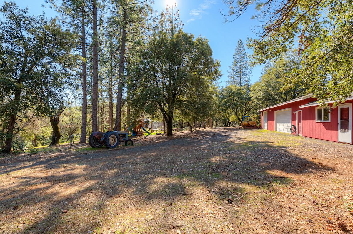 179 Elams Ranch Road Oroville, CA 95966 - Photo 20 of 52 a view of a house with a large space and a car parked beside it