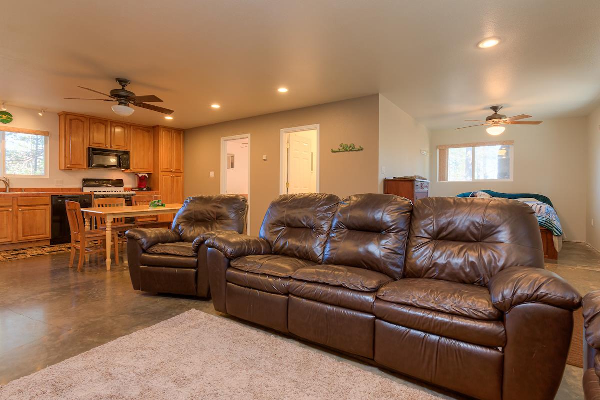 179 Elams Ranch Road Oroville, CA 95966 - Photo 6 of 52 a living room with furniture a kitchen and a wooden floor