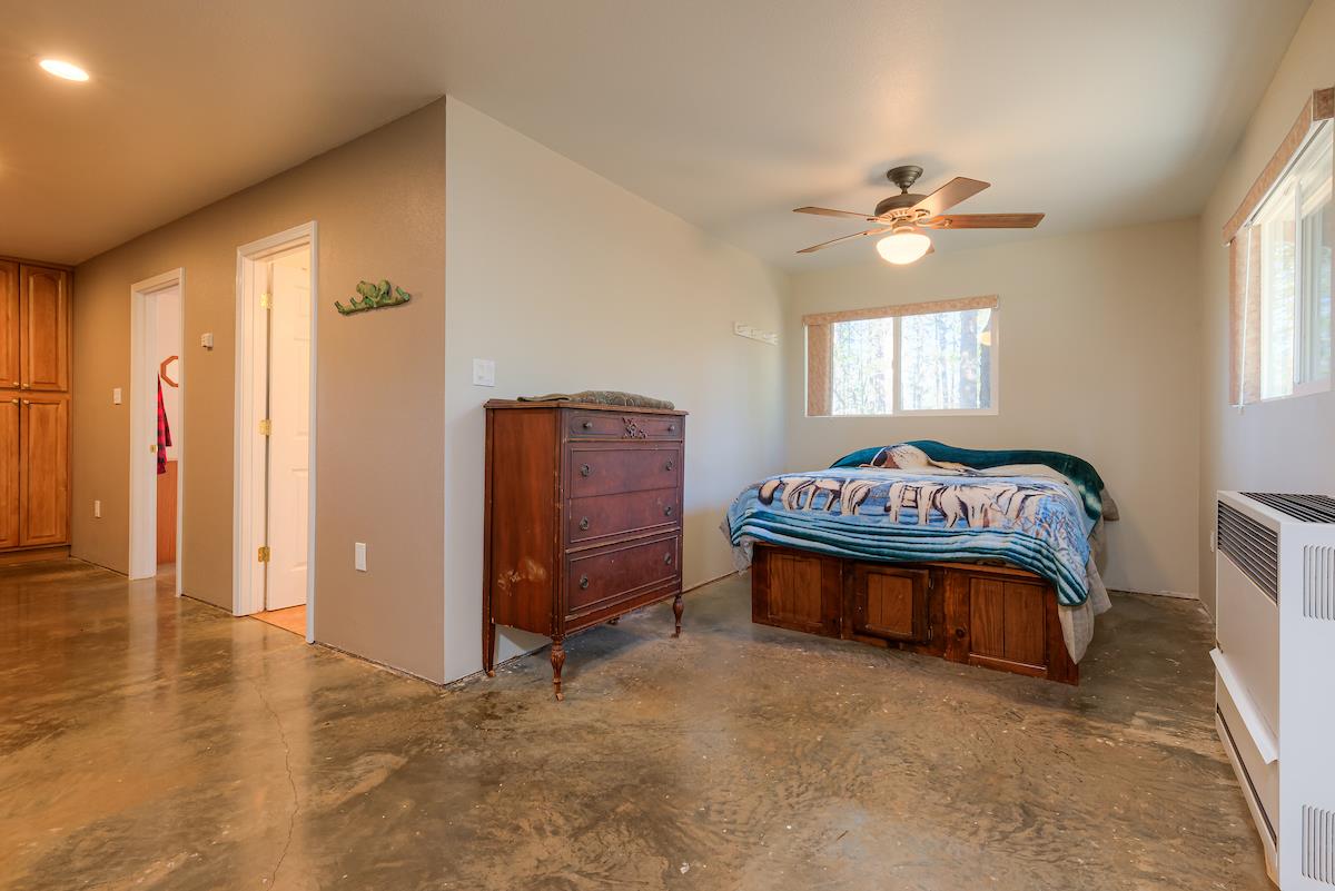 179 Elams Ranch Road Oroville, CA 95966 - Photo 7 of 52 a bedroom with a bed and a chandelier