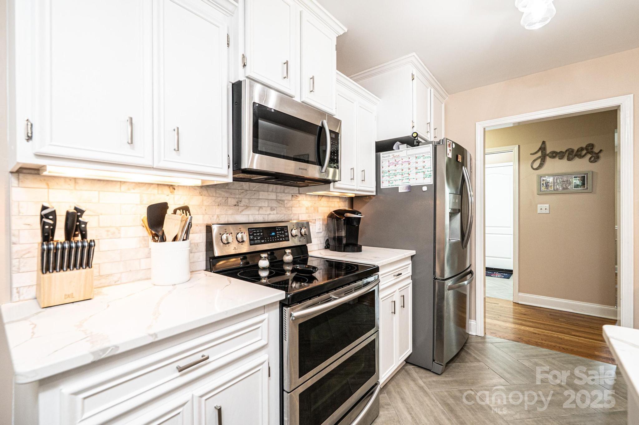 1784 New Star Drive Newton, NC 28658 - Photo 11 of 27 a kitchen with stainless steel appliances a stove microwave and refrigerator