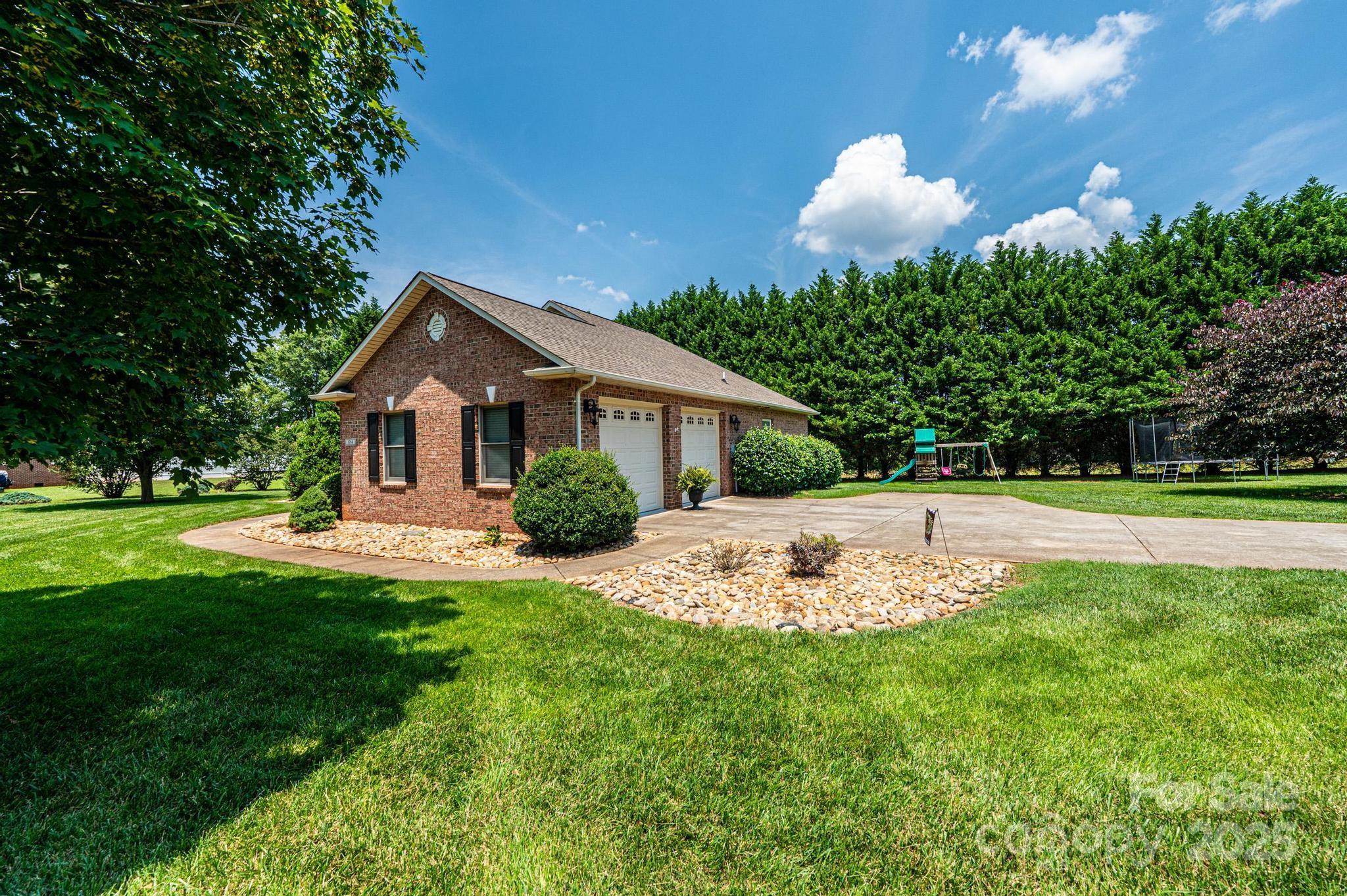 1784 New Star Drive Newton, NC 28658 - Photo 22 of 27 a front view of a house with garden and porch