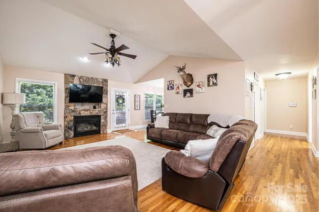 a living room with furniture a fireplace and a flat screen tv