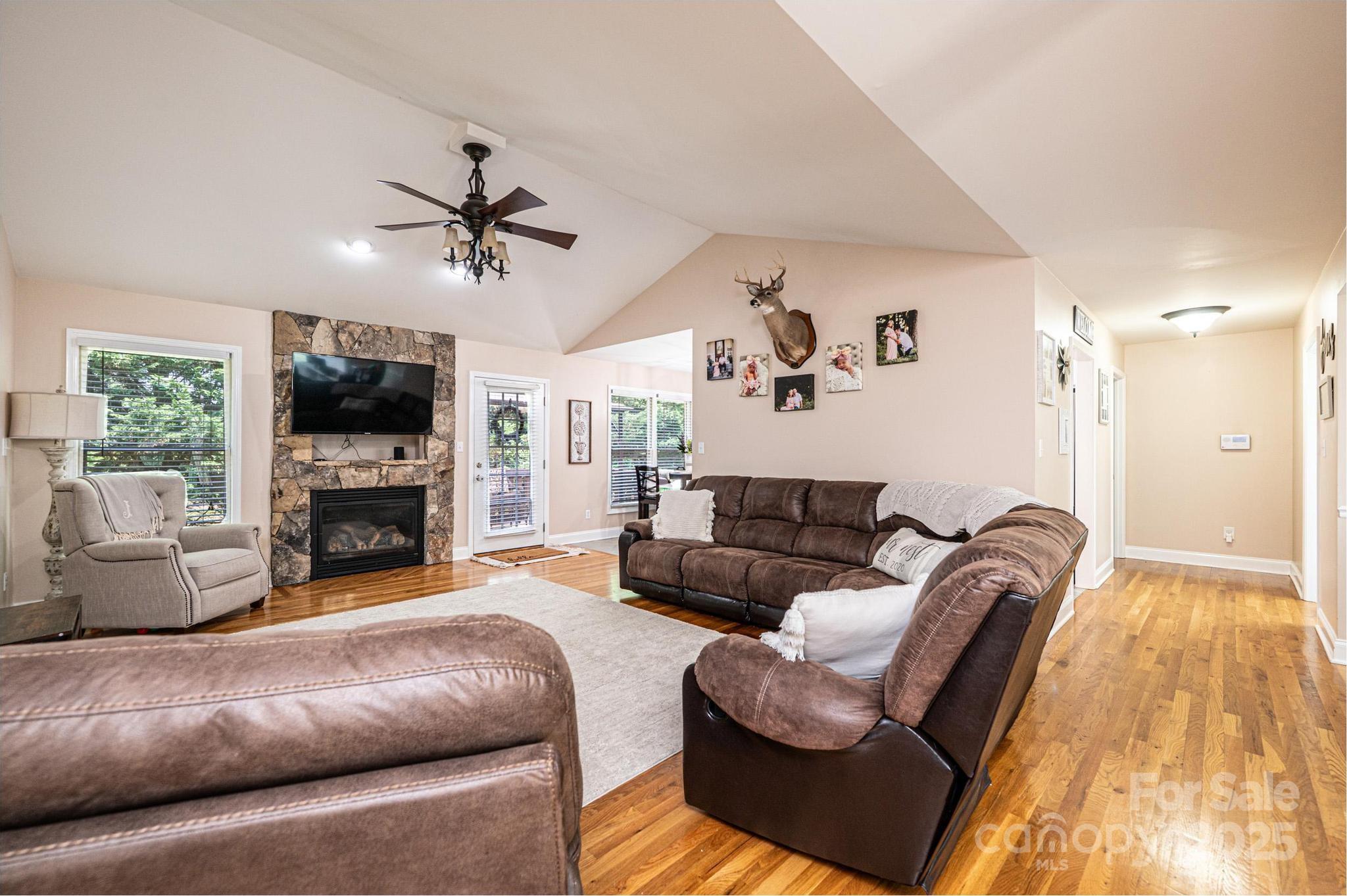 1784 New Star Drive Newton, NC 28658 - Photo 5 of 27 a living room with furniture a fireplace and a flat screen tv