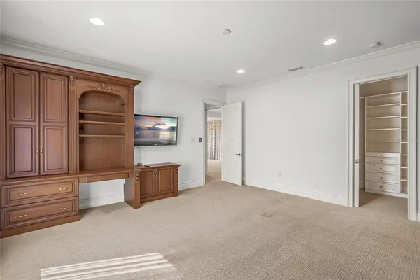 a view of walk in closet with empty racks