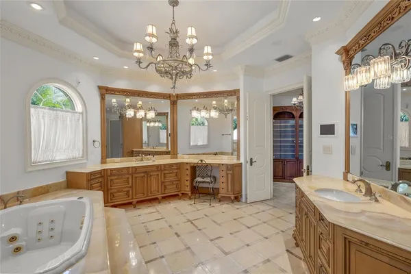 a spacious bathroom with a granite countertop tub sink shower and mirror
