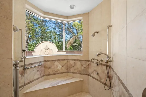 a view of an empty room with a fireplace and a large window