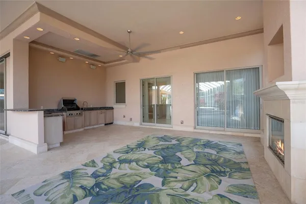 a view of a livingroom with a fireplace and window
