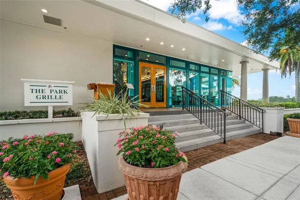 a kitchen with stainless steel appliances kitchen island granite countertop lots of white cabinets
