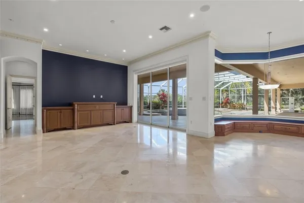 a view of a hall with kitchen and windows